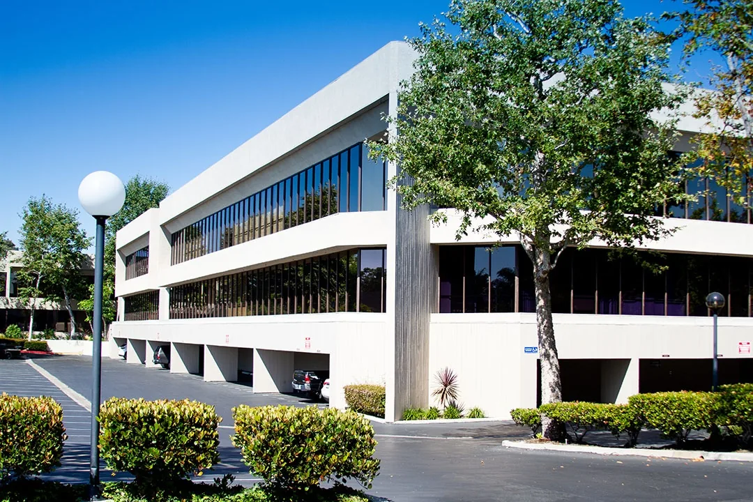 Newport Atrium low-rise office exterior and parking access — Chase Merritt