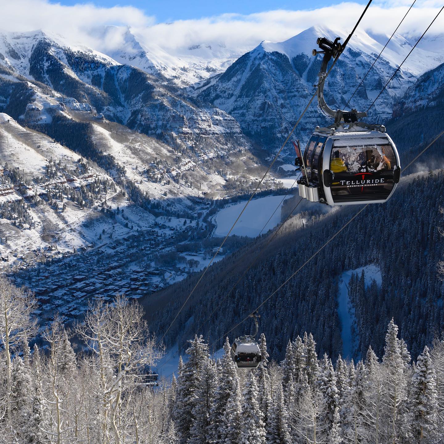 Telluride gondola traveling above a snow-covered valley